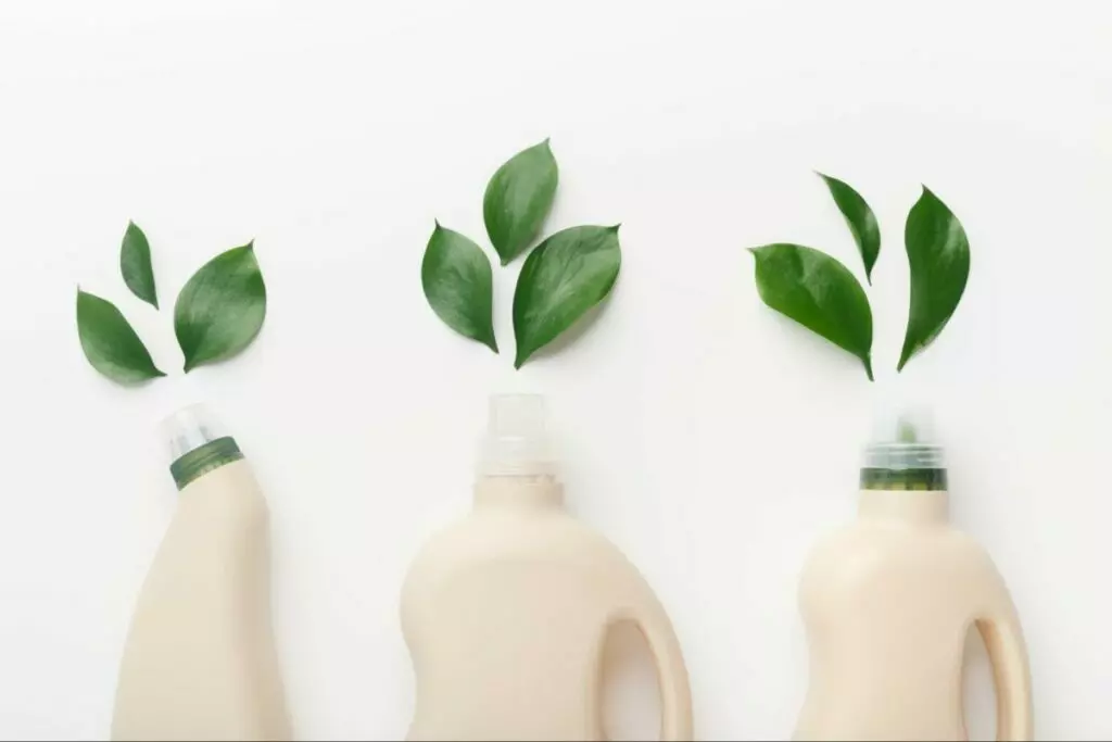 Three bottles with green leaves on a white background in Boston.