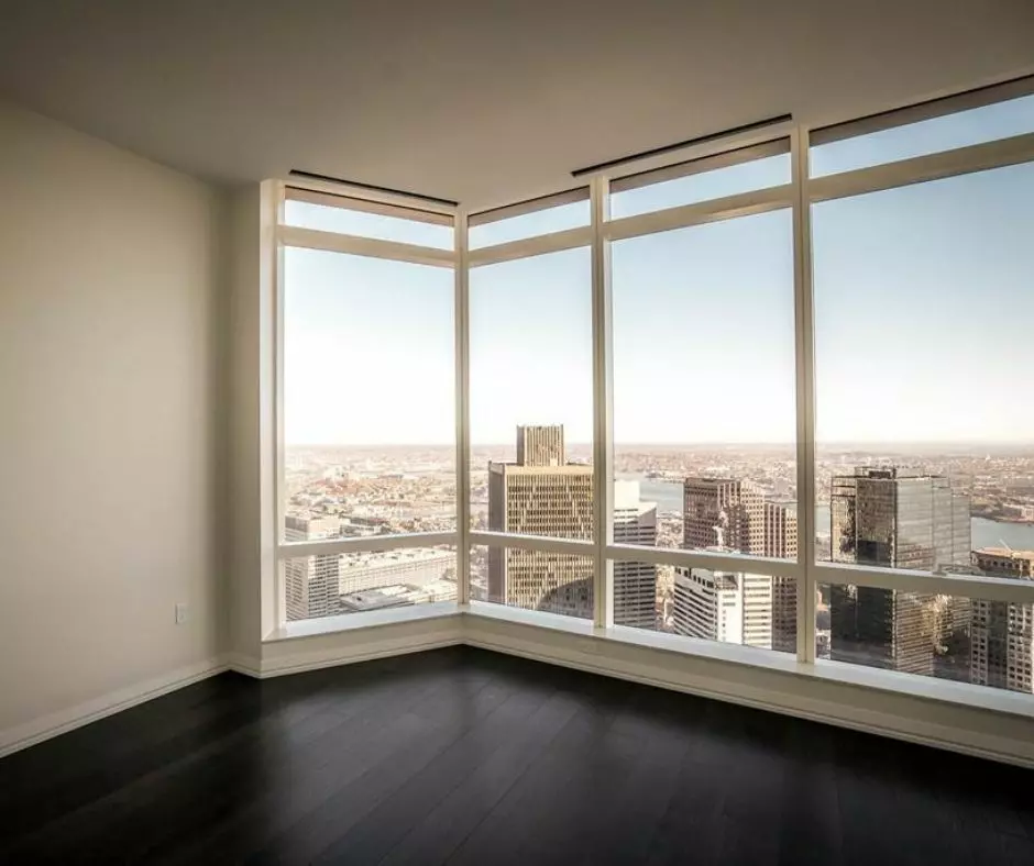 An empty room with large windows overlooking the city, perfect for templates.