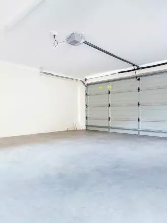 An empty garage with two garage doors available for move in or move out.