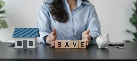 Using a block, a woman promotes "save" as an effective template to encourage apartment cleaning.