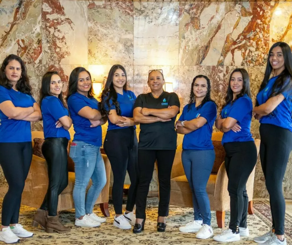 A group of women in blue shirts posing for a photo.