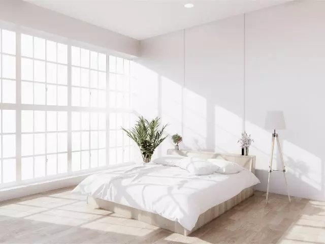 Bright and minimalistic bedroom with a large window, white bedding, and a floor lamp, complemented by bedroom cleaning templates.